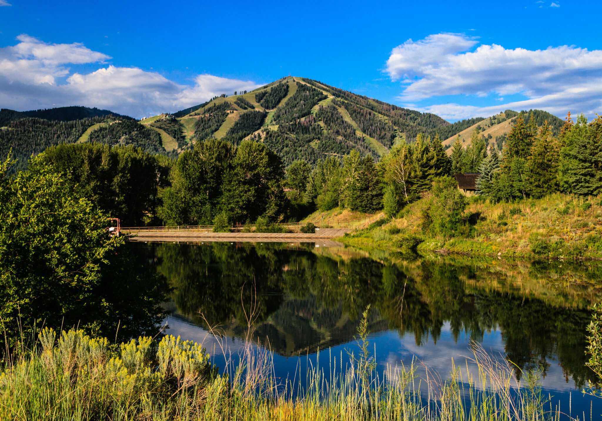 A summer view of Bald Mountain in Sun Valley, with reflection